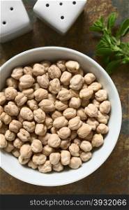 Raw chickpeas or garbanzo beans in bowl, photographed overhead with natural light