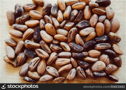 Raw cocoa beans on a wooden board. Raw cocoa beans