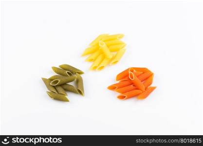 Raw colored pasta isolated on white background. Tomato, spinach and wheat