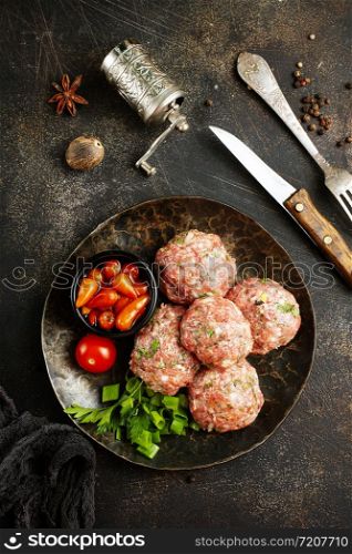 raw cutlets with salt and spice, minced meat on plate