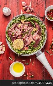 Raw double lamb loin chops meat in white pan with herbs,oil and spices on red wooden background, top view, close up