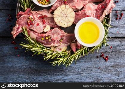 Raw double lamb loin chops on rustic blue wooden background, top view, close up