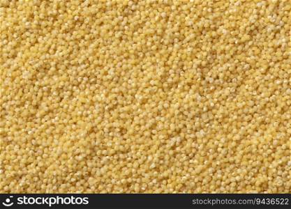 Raw dry yellow millet close up full frame as background 