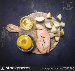raw duck breast with pears, peaches and honey on a cutting board on wooden rustic background top view close up