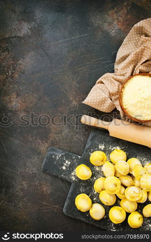 raw dumplings on board and on a table