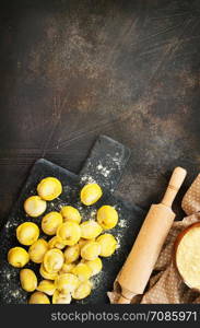 raw dumplings on board and on a table