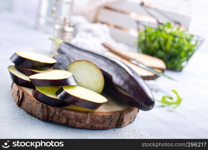 raw eggplant and knife on board, fresh eggplant