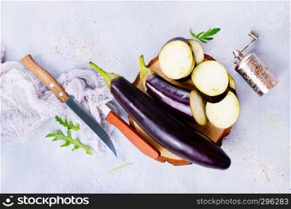 raw eggplant and knife on board, fresh eggplant