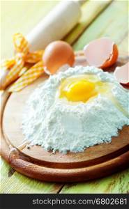 raw eggs and flour on a table