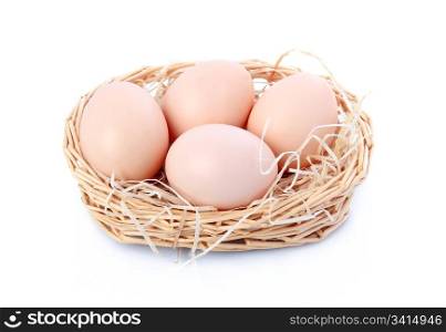 Raw eggs in basket isolated on white background