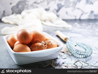 raw eggs in bowl and on a table