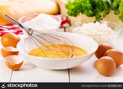 raw eggs in bowl on wooden table