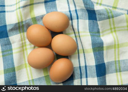 Raw eggs on a blue napkin. Healthy meal