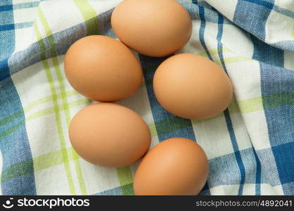 Raw eggs on a blue napkin. Healthy meal