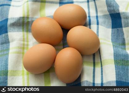 Raw eggs on a blue napkin. Healthy meal