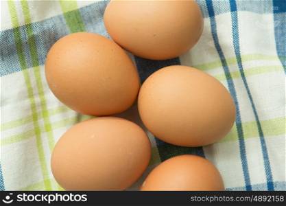Raw eggs on a blue napkin. Healthy meal