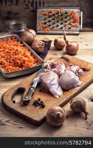 raw fillet of chicken meat and onions in the process of cooking food. fillet of chicken meat