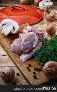 raw fillet of chicken meat and onions in the process of cooking food. raw fillet of chicken meat