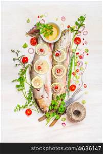 Raw fish, colorful seasonning and delicious ingredients for Healthy cooking on white wooden background, top view