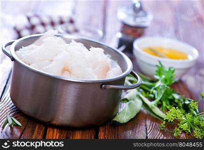 raw fish fillet in bowl and on a table