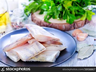 raw fish fillet on plate and on a table