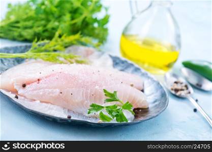 raw fish fillet on the metal plate