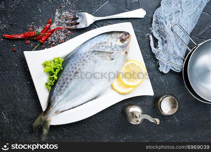 raw fish with fresh lemon on plate