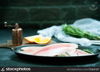raw fish with spice and on a table