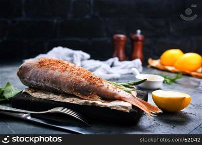 raw fish with spice and salt on a table