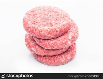 Raw fresh beef burgers on white background with reflection