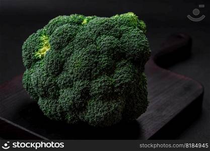 Raw fresh broccoli on a black home kitchen tab≤. Cooking vegan food