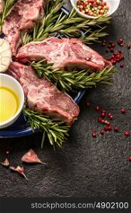 Raw fresh Lamb Meat , oil and seasonings on dark background, close up