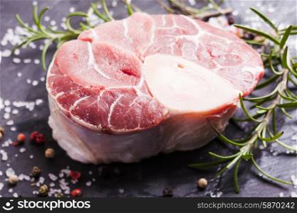 Raw fresh slice of meat - cross cut veal shank on a slate board