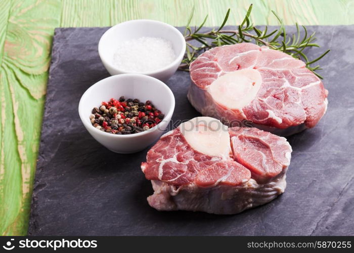 Raw fresh slice of meat - cross cut veal shank on a slate board