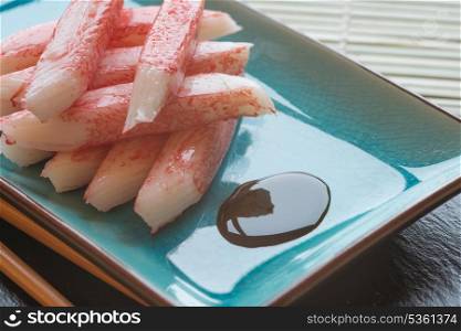 Raw fresh sushi carbsticks on plate with chopsticks
