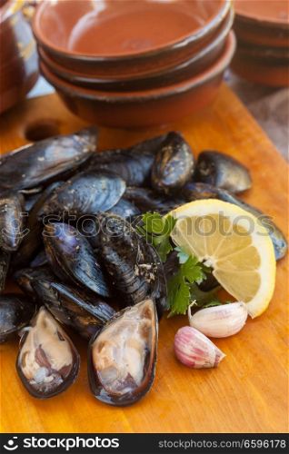 Raw fresh tasty mussel with parsley and lemon