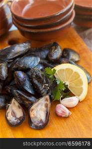 Raw fresh tasty mussel with parsley and lemon