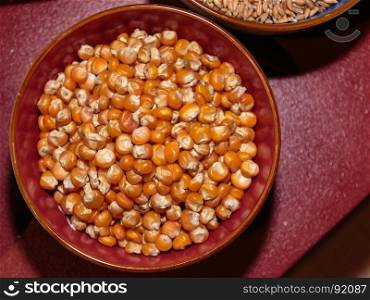 Raw Grains of Corn inside Bowl, Orange Kernels Top View