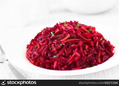 Raw grated beetroot, apple and carrot salad with parsley, photographed with natural light (Selective Focus, Focus in the middle of the image). Raw Grated Beetroot, Apple and Carrot Salad