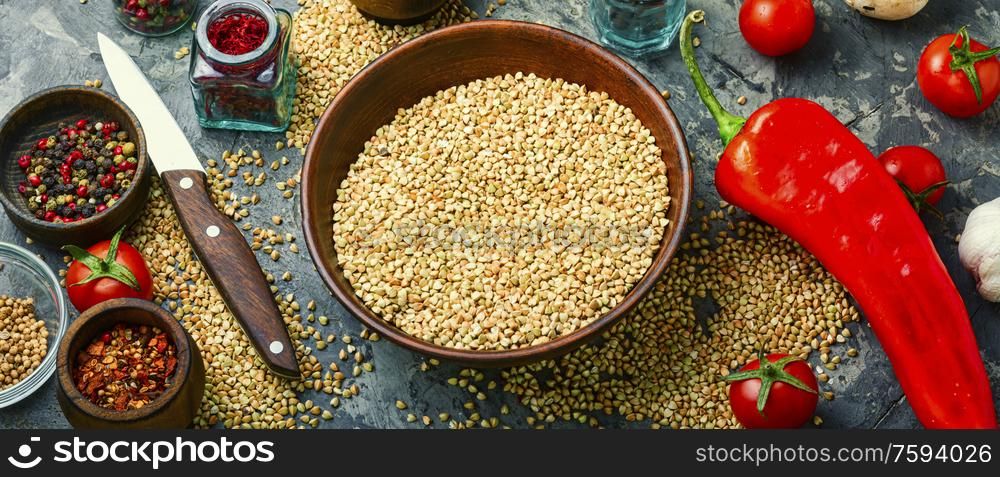 Raw green buckwheat in a bowl,pile of buckwheat. Useful green buckwheat