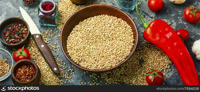 Raw green buckwheat in a bowl,pile of buckwheat. Useful green buckwheat