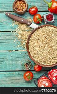 Raw green buckwheat on wooden background,vegan food.Diet concept. Green buckwheat on wooden table