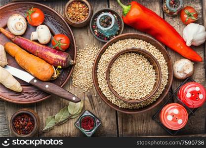 Raw green buckwheat on wooden background,vegan food. Green buckwheat on wooden table