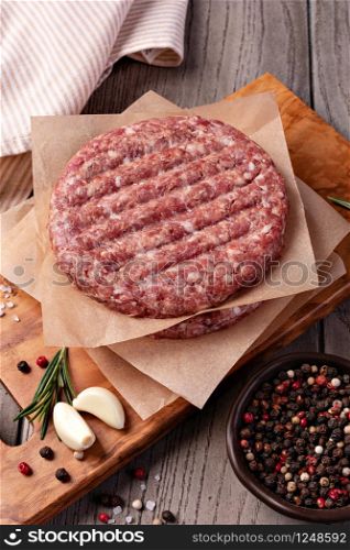 Raw Ground beef meat Burger steak cutlets on wooden background. Raw Ground beef meat