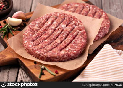 Raw Ground beef meat Burger steak cutlets on wooden background. Raw Ground beef meat