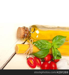 raw ingredients spaghetti pasta tomato and basil foundations of Italian cuisine