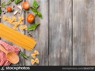 Raw Italian pasta with tomato sauce ingredients with copy space