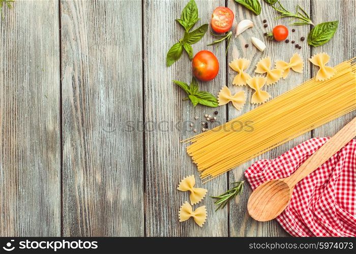Raw Italian pasta with tomato sauce ingredients with copy space. Italian pasta