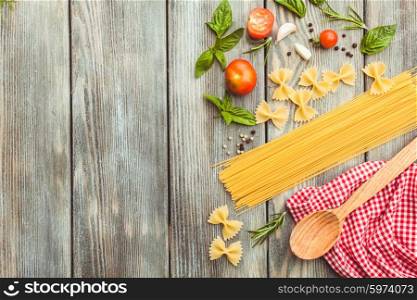 Raw Italian pasta with tomato sauce ingredients with copy space. Italian pasta