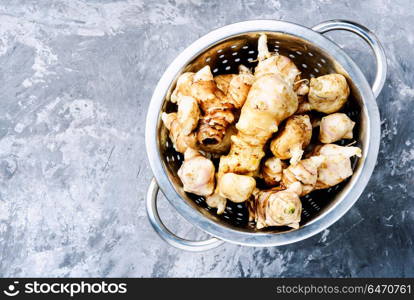 Raw Jerusalem artichokes. Harvest raw Jerusalem artichokes in a colander